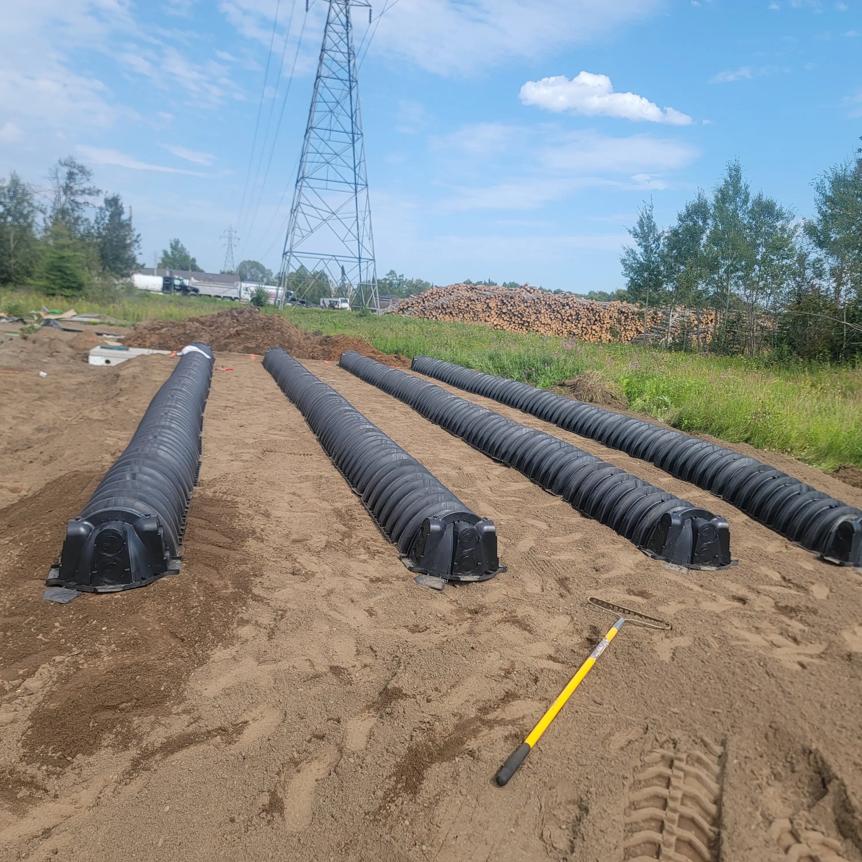 Drain field lines laid out on a job site for a Rega client
