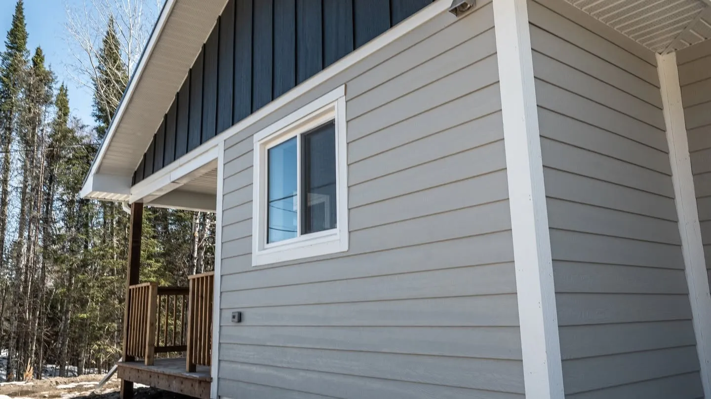 New siding and a porch on a house built by a Rega client
